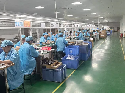 Workers operating an electronics assembly workshop